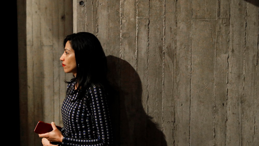 Huma Abedin, longtime aide to Democratic presidential candidate Hillary Clinton, watches as Clinton greets attendees after a campaign event at Iowa State University in Ames, Iowa, Jan. 12, 2016. (Photo by Patrick Semansky/AP)