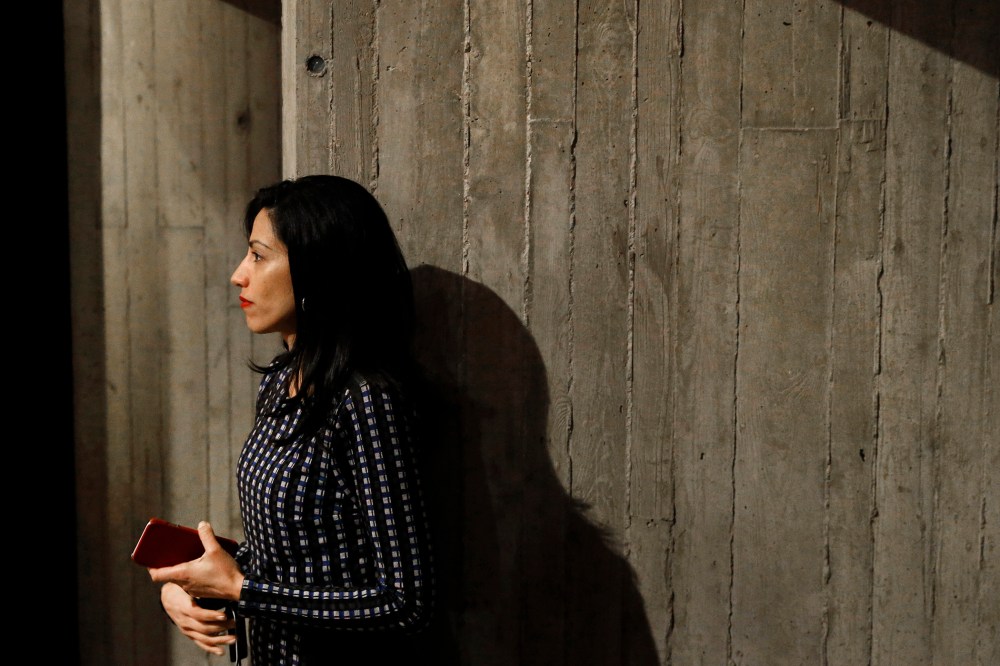 Huma Abedin, longtime aide to Democratic presidential candidate Hillary Clinton, watches as Clinton greets attendees after a campaign event at Iowa State University in Ames, Iowa, Jan. 12, 2016. (Photo by Patrick Semansky/AP)