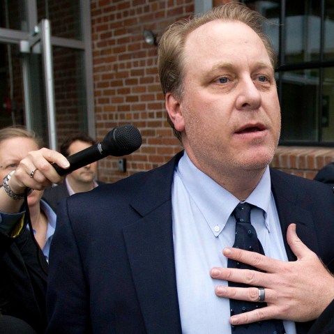 In this May 16, 2012, file photo, former Boston Red Sox pitcher Curt Schilling, center, is followed by members of the media as he departs the Rhode Island Economic Development Corporation headquarters, in Providence, R.I. (Photo by Steven Senne/AP)