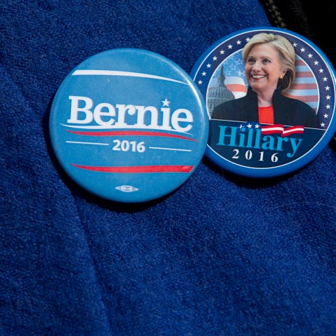 A voter wears buttons for Democratic presidential candidates Sen. Bernie Sanders, I-Vt., and Hillary Clinton buttons, March 31, 2016, in New York. (Photo by Mary Altaffer/AP)