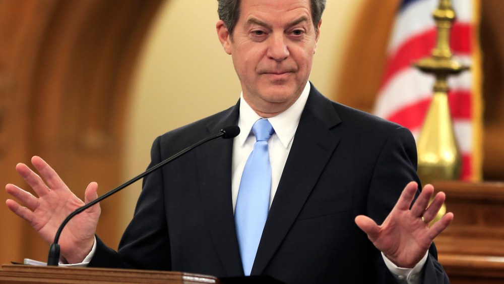In this Jan. 12, 2016 file photo, Kansas Gov. Sam Brownback speaks to the legislature in Topeka, Kan. (Photo by Orlin Wagner/AP)