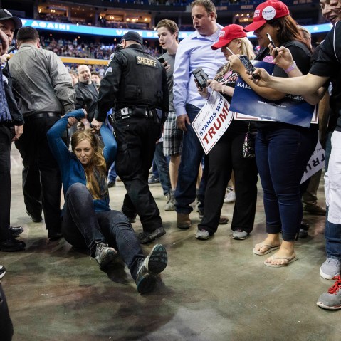 A protestor is dragged away by authorities as Republican presidential candidate Donald Trump speaks during a campaign stop at the First Niagara Center, April 18, 2016, in Buffalo, N.Y. (Photo by John Minchillo/AP)
