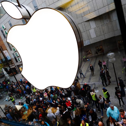 In this Friday, Sept. 25, 2015, file photo, people wait in front of the Apple store in Munich, before the worldwide launch of the iPhone 6s. (Photo by Matthias Schrader/AP)