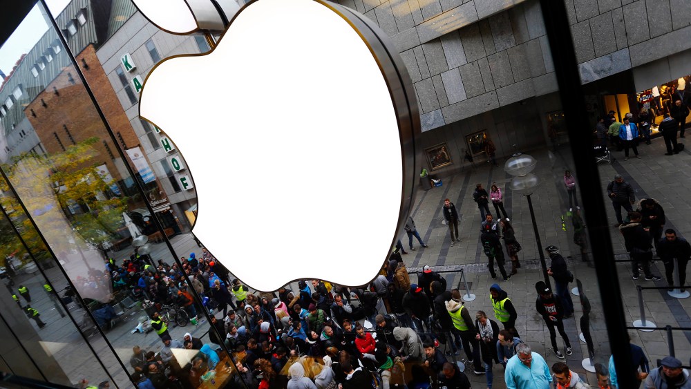 In this Friday, Sept. 25, 2015, file photo, people wait in front of the Apple store in Munich, before the worldwide launch of the iPhone 6s. (Photo by Matthias Schrader/AP)