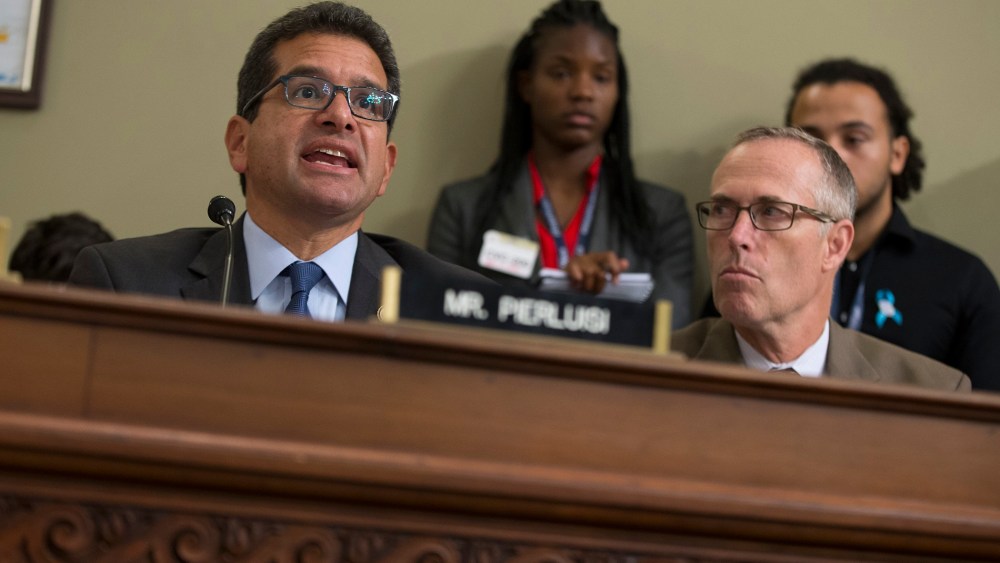 Rep. Jared Huffman, D-Calif. listens at right as Puerto Rico's Resident Commission Pedro Pierluisi, D-Puerto Rico, speaks on Capitol Hill in Washington, May 25, 2016. (Photo by Evan Vucci/AP)