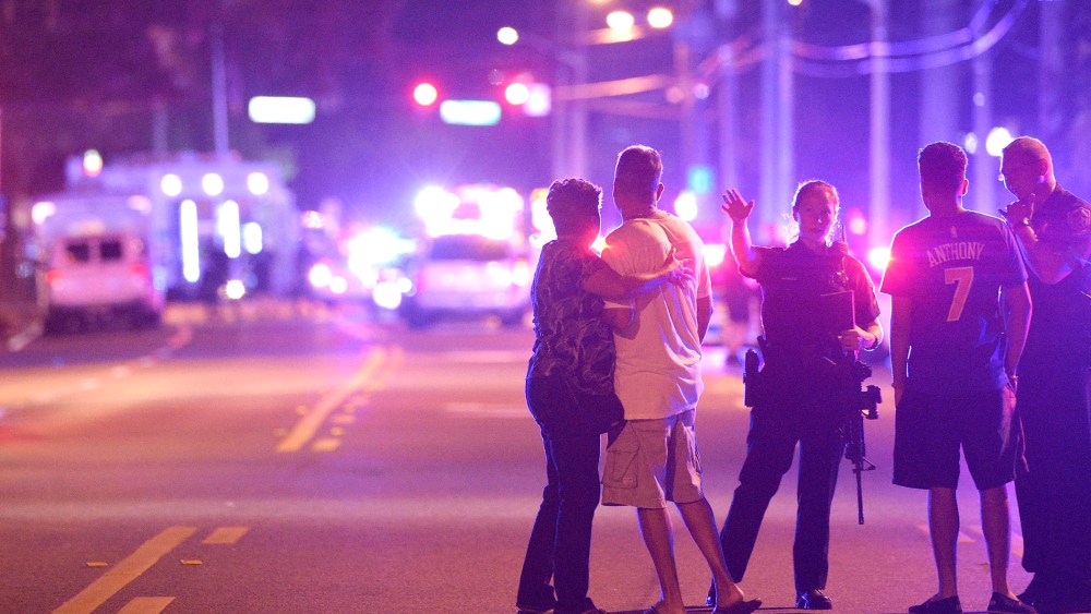 Orlando Police officers direct family members away from a fatal shooting at Pulse Orlando nightclub in Orlando, Fla., June 12, 2016. (Photo by Phelan M. Ebenhack/AP)