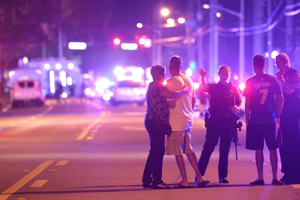 Orlando Police officers direct family members away from a fatal shooting at Pulse Orlando nightclub in Orlando, Fla., June 12, 2016. (Photo by Phelan M. Ebenhack/AP)