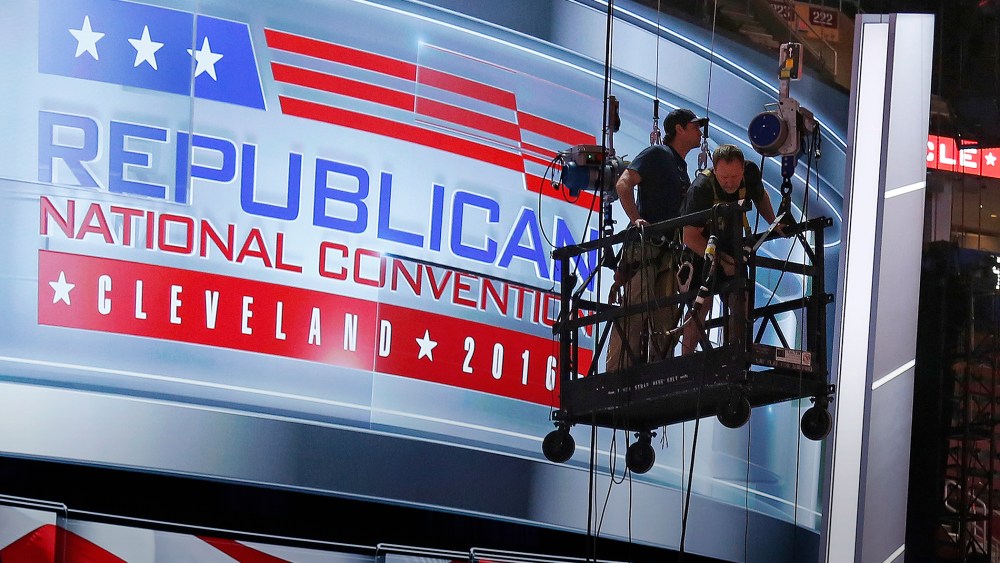 The main stage on the convention floor at the Quicken Loans Arena in downtown Cleveland, Ohio, is prepared for the upcoming RNC, as workers stand in a man lift, July 13, 2016. (Photo by Gene J. Puskar/AP)