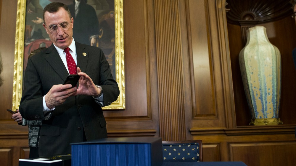 Rep. Tim Murphy, R-Pa., take a photo of the 21st Century Cures Act prior to a signing ceremony on Capitol Hill in Washington, Thursday, Dec. 8, 2016.