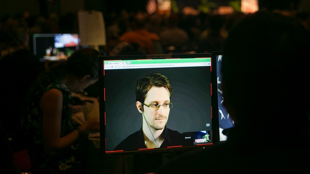 A video technician monitors a computer screen as Edward Snowden appears on a live video feed broadcast from Moscow at an event sponsored by the ACLU Hawaii in Honolulu on Feb. 14, 2015. (Photo by Marco Garcia/AP)