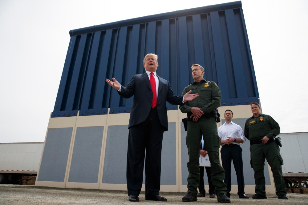President Donald Trump talks with reporters as he reviews border wall prototypes, Tuesday, March 13, 2018, in San Diego.