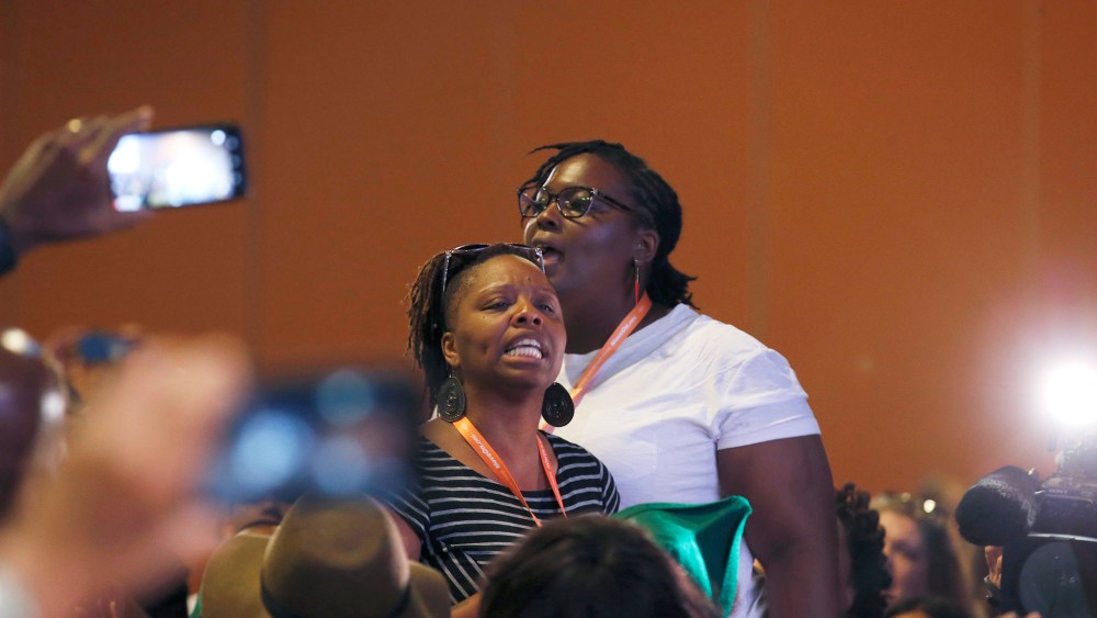Black Lives Matter and Black Immigration Network activists shout down the first of two Democratic presidential candidates speakers at a Netroots Nation town hall meeting on July 18, 2015, in Phoenix, Ariz. (Photo by Ross D. Franklin/AP)