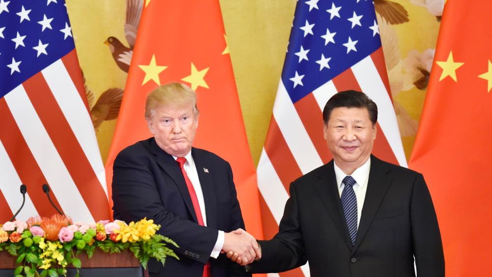 Photo shows U.S. President Donald Trump (L) and Chinese President Xi Jinping shaking hands during a joint press conference at the Great Hall of the People in Beijing in November 2017.