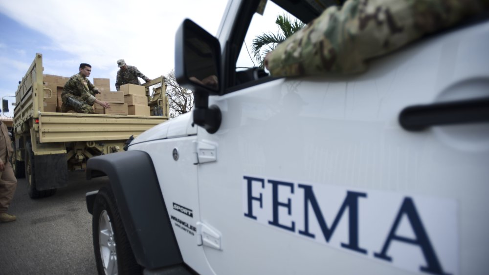 In this Oct. 5, 2017 file photo, Department of Homeland Security personnel deliver supplies to Santa Ana community residents in the aftermath of Hurricane Maria in Guayama, Puerto Rico.