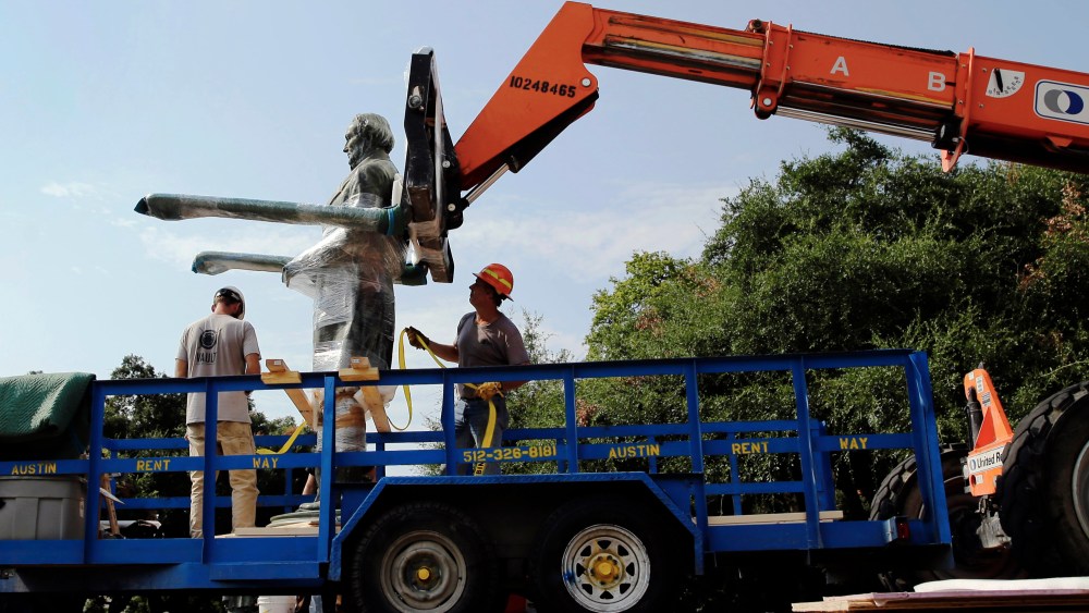 A statue of Confederate President Jefferson Davis is moved from its location in front of the school's main tower the University of Texas campus, Sunday, Aug. 30, 2015, in Austin, Texas. (Photo by Eric Gay/AP)