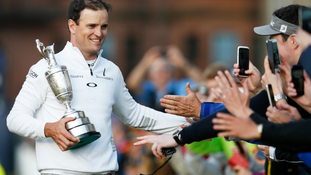 United States’ Zach Johnson celebrates with members of the public as he holds the trophy after winning a playoff after the final round at the British Open Golf Championship at the Old Course, St. Andrews, Scotland on July 20, 2015. (Photo by Jon Super/AP)