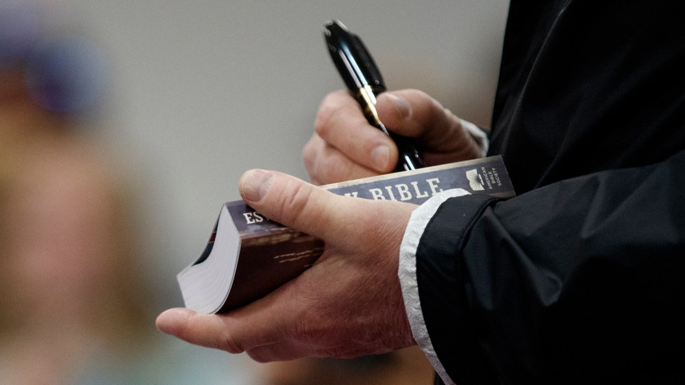 President Donald Trump signs a Bible as he greets people at Providence Baptist Church in Smiths Station, Ala., Friday, March 8, 2019, as they travel to tour areas where tornados killed 23 people in Lee County, Ala.