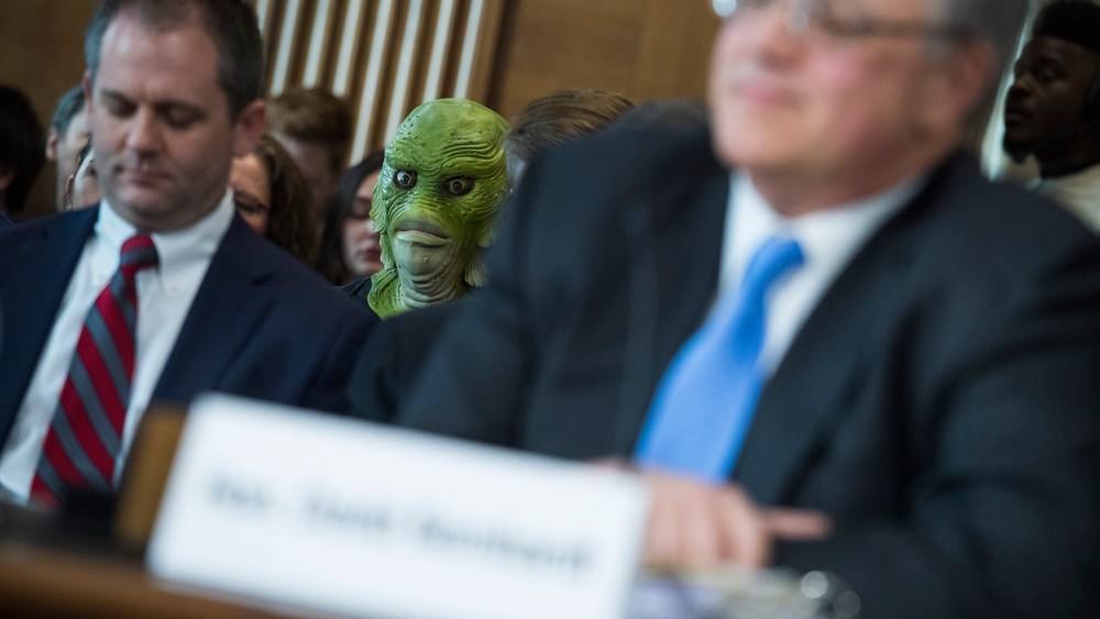 A protester is seen during the during the Senate Energy and Natural Resources Committee confirmation hearing for David Bernhardt, nominee to be Secretary of the Interior, March 28, 2019.