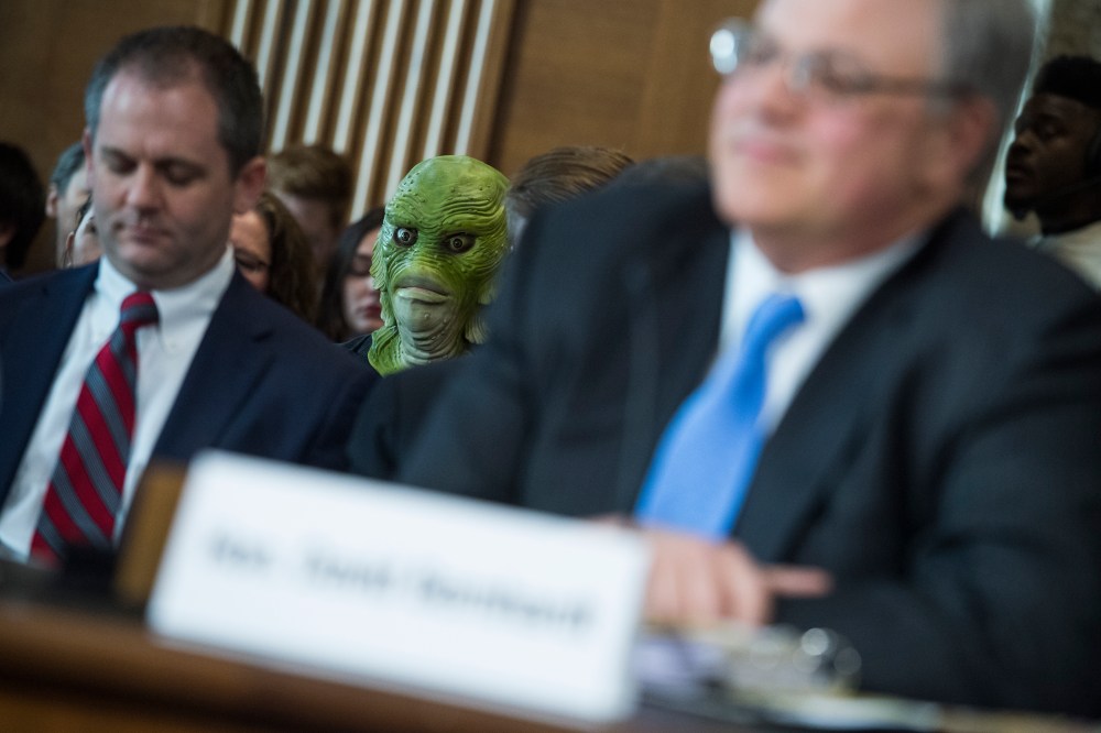 A protester is seen during the during the Senate Energy and Natural Resources Committee confirmation hearing for David Bernhardt, nominee to be Secretary of the Interior, March 28, 2019.