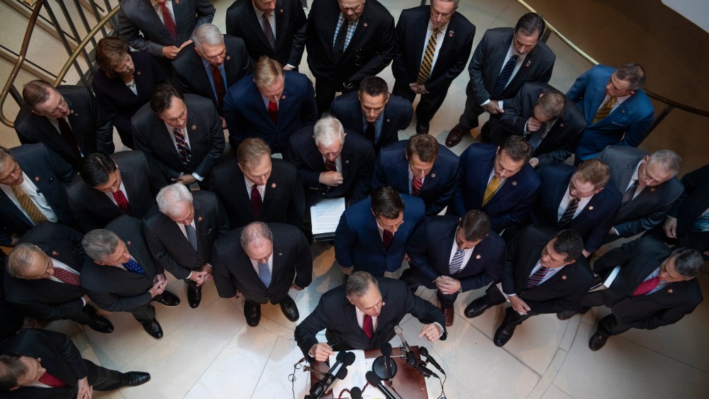 Rep. Andy Biggs, R-Ariz., at podium, speaks during a news conference in the Capitol Visitor Center outside the Laura Cooper, deputy assistant secretary of defense, deposition related to the House's impeachment inquiry on Wednesday, October 23, 2019.