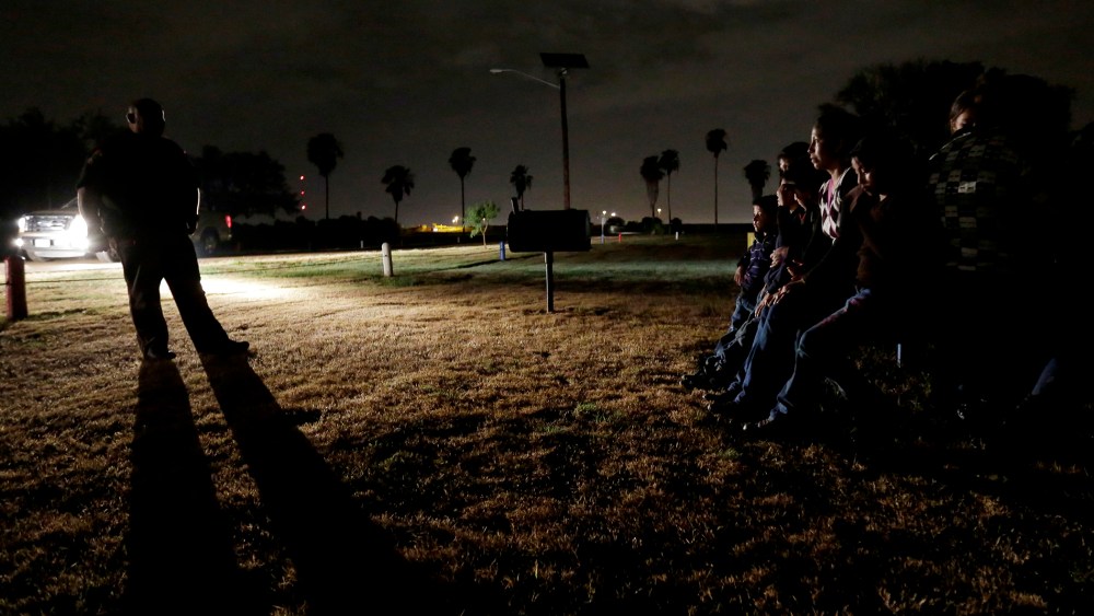 In this June 25, 2014, file photo, a group of immigrants from Honduras and El Salvador, who crossed the U.S.-Mexico border illegally, are stopped in Granjeno, Texas. (Photo by Eric Gay/AP)