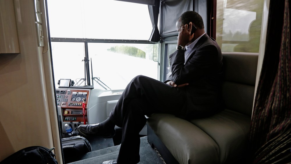 Republican presidential candidate, retired neurosurgeon Ben Carson answers a question during a phone interview as he travels on his bus tour near Lexington, N.C., Sept. 28, 2015. (Photo by Chuck Burton/AP)