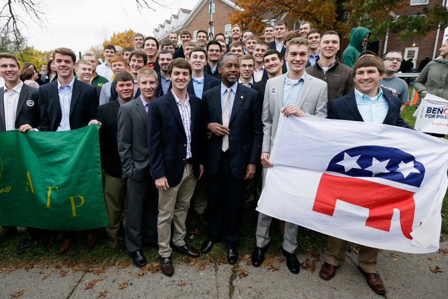 Republican presidential candidate Dr. Ben Carson poses for a photo with Alpha Gamma Rho fraternity members at Iowa State University following a campaign stop, Oct. 24, 2015, in Ames, Iowa. (Photo by Charlie Neibergall/AP)