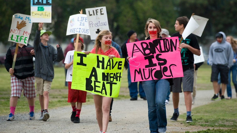 Pro-life protesters attend an annual Walk for Life, held by the Porterville Pregnancy Center Saturday, April 5, 2014 in Porterville, Calif. (Photo by Chieko Hara/The Porterville Recorder/AP)