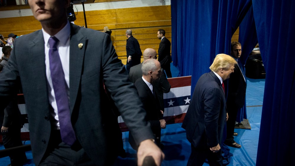 Republican presidential candidate Donald Trump, right, smiles as leaves the gym after a rally, Jan. 12, 2016, in Cedar Falls, Iowa. (Photo by Jae C. Hong/AP)