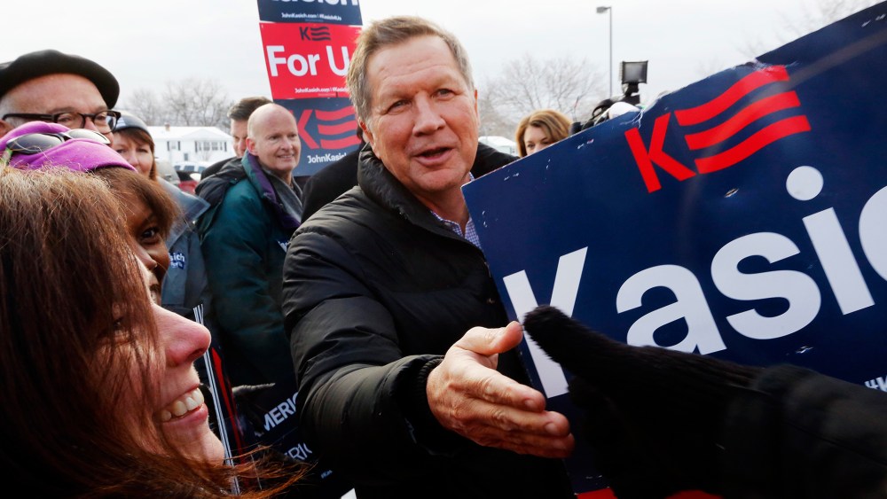 Republican presidential candidate, Ohio Gov. John Kasich greets supporters at a polling station at the high school, Feb. 9, 2016, in Manchester, N.H. (Photo by Jim Cole/AP)