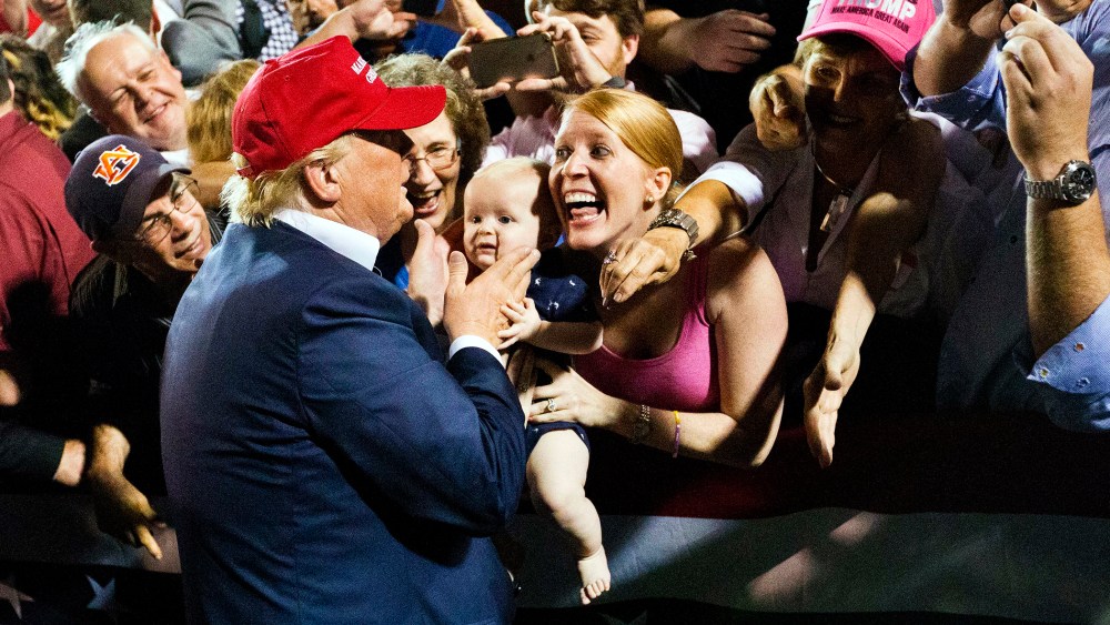 A woman with her baby shows excitement when the Republican presidential candidate Donald Trump greets them after he speaks at a campaign pep rally, Friday, Aug. 21, 2015, in Mobile, Ala. (Photo by Brynn Anderson/AP)