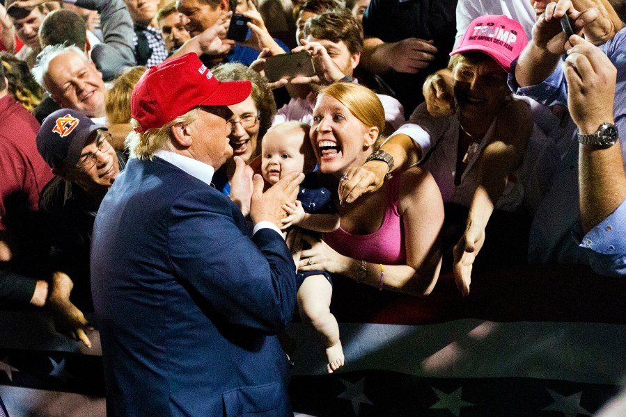 A woman with her baby shows excitement when the Republican presidential candidate Donald Trump greets them after he speaks at a campaign pep rally, Friday, Aug. 21, 2015, in Mobile, Ala. (Photo by Brynn Anderson/AP)