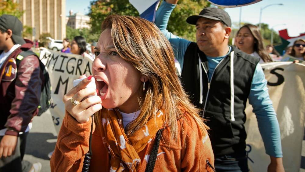 Jeanette Trejo chants as she marches during an immigration reform rally on Nov. 21, 2015, in Austin, Texas. (Photo by Jay Janner/Austin American-Statesman/AP)
