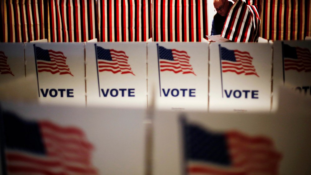 Jim Smith steps out of a voting booth after marking his ballot at a polling site for the New Hampshire primary, Feb. 9, 2016, in Nashua, N.H. (Photo by David Goldman/AP)