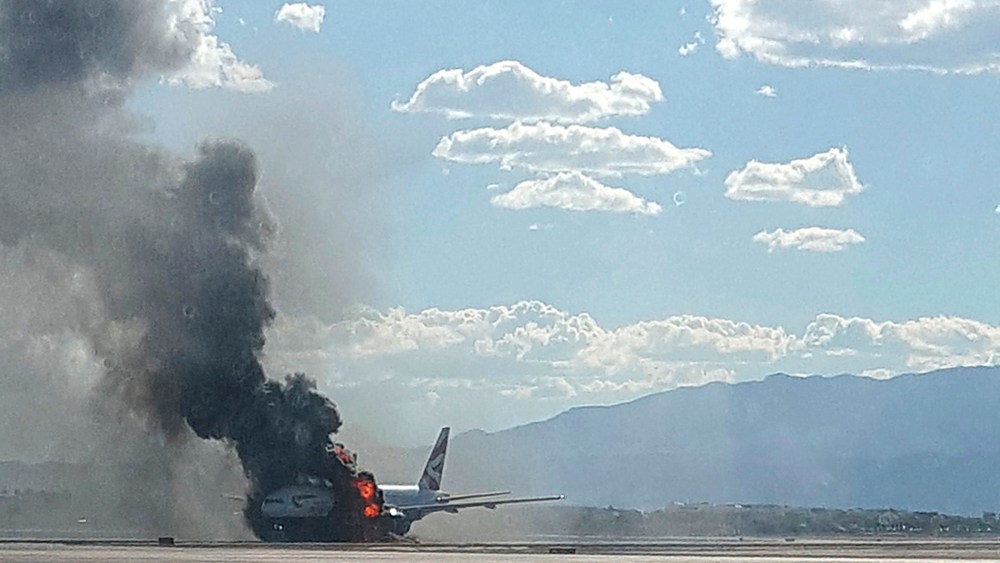 Smoke billows out from a plane that caught fire at McCarren International Airport on Sept. 8, 2015, in Las Vegas, Nev. (Photo by Eric Hays/AP)