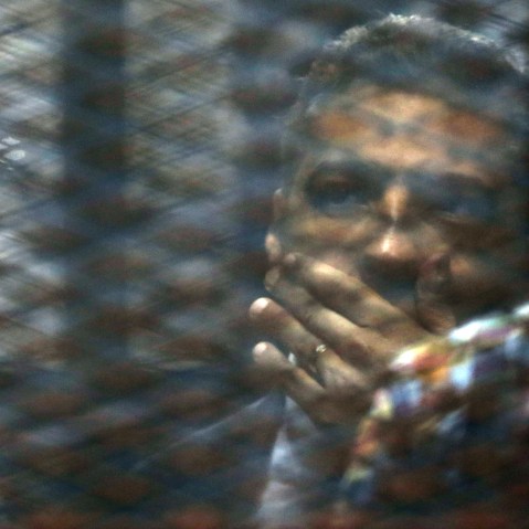 Canadian Al-Jazeera English journalist Mohammed Fahmy, listens to his verdict in a soundproof glass cage inside a makeshift courtroom in Tora prison in Cairo, Egypt, Aug. 29, 2015. (Photo by Amr Nabil/AP)