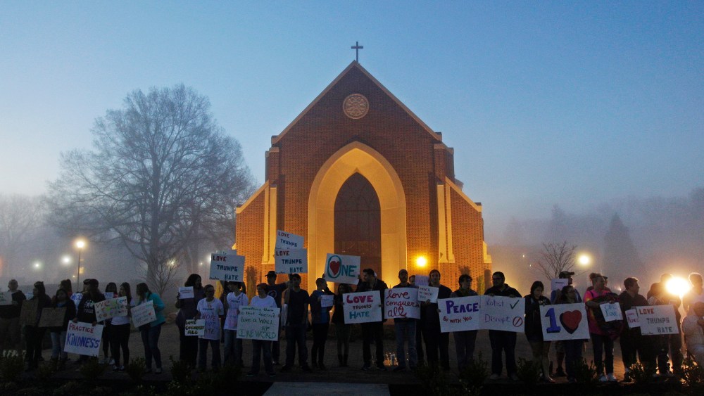 Protesters wait before dawn outside a church at Lenoir-Rhyne University before a rally for Republican presidential candidate Donald Trump in Hickory, N.C., March 14, 2016. (Photo by Chuck Burton/AP)