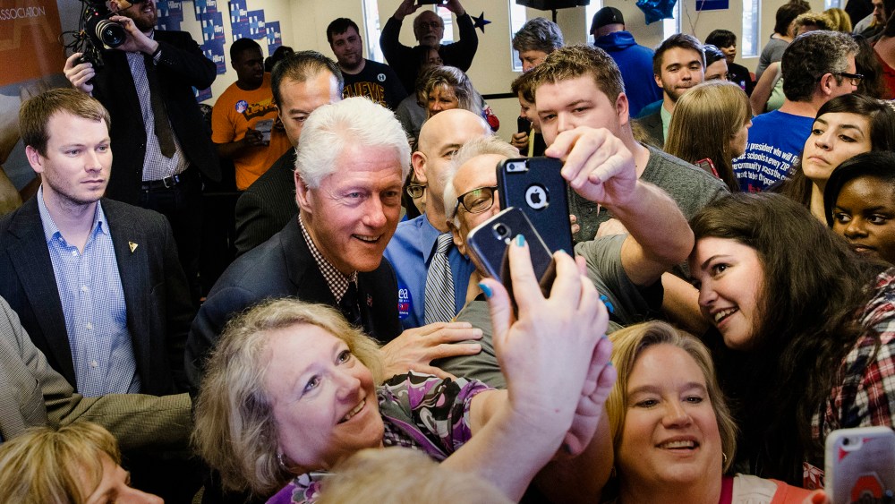 Former President Bill Clinton has pictures taken with attendees as he campaigns for his wife, Democratic presidential candidate, Hillary Clinton, March 9, 2016, Columbus, Ohio. (Photo by John Minchillo/AP)