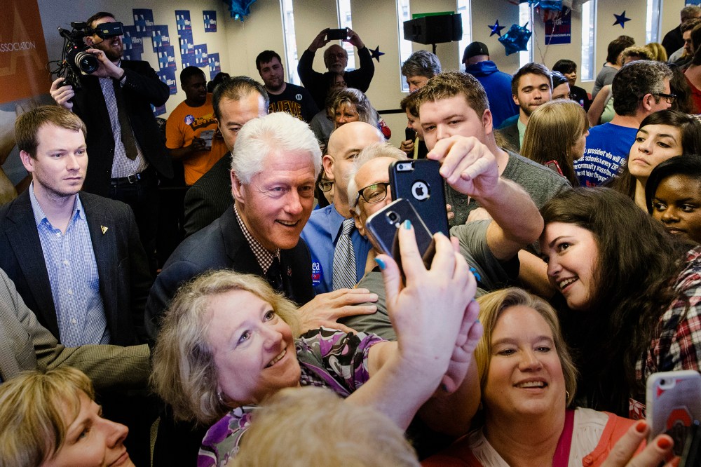 Former President Bill Clinton has pictures taken with attendees as he campaigns for his wife, Democratic presidential candidate, Hillary Clinton, March 9, 2016, Columbus, Ohio. (Photo by John Minchillo/AP)