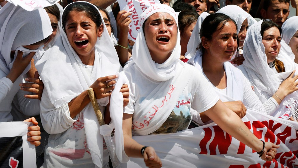 Yazidi Kurdish women chant slogans during a protest against the Islamic State in Dohuk, northern Iraq, Aug. 3, 2015. (Photo by Seivan M. Salim/AP)