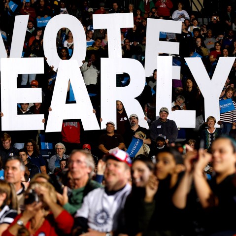 In this Oct. 29, 2012 file photo a "Vote Early" sign is held up by supporters at a rally for President Barack Obama in Youngstown, Ohio, referring to the "golden week" now in contention. (Photo by Matt Rourke/AP)