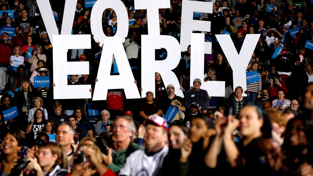 In this Oct. 29, 2012 file photo a "Vote Early" sign is held up by supporters at a rally for President Barack Obama in Youngstown, Ohio, referring to the "golden week" now in contention. (Photo by Matt Rourke/AP)