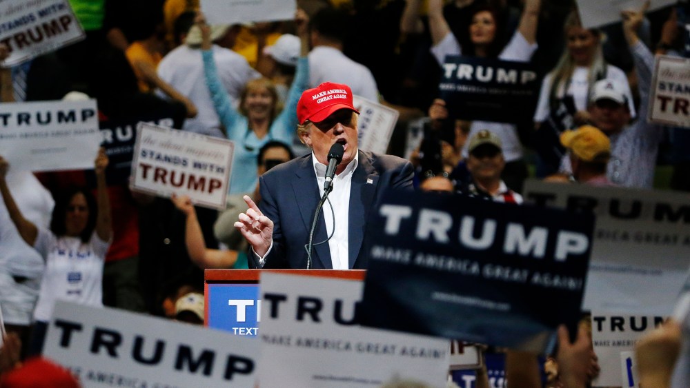 Among the waving of campaign signs, Republican presidential candidate Donald Trump speaks during a campaign rally, March 19, 2016, in Tucson, Ariz. (Photo by Ross D. Franklin/AP)