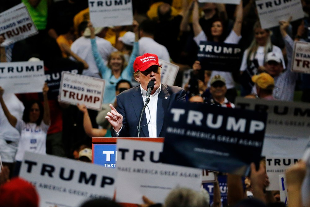 Among the waving of campaign signs, Republican presidential candidate Donald Trump speaks during a campaign rally, March 19, 2016, in Tucson, Ariz. (Photo by Ross D. Franklin/AP)