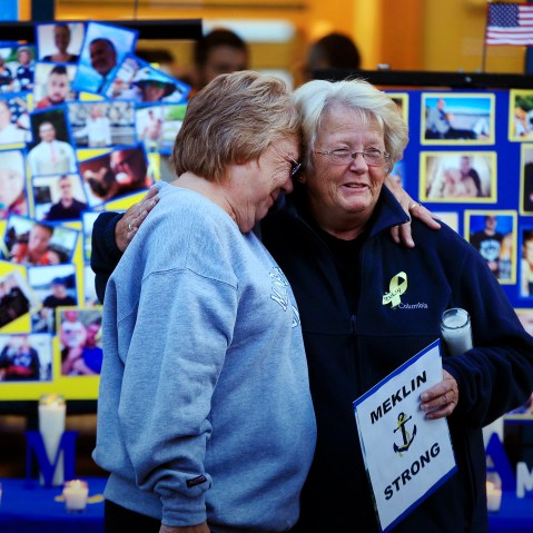 Deborah Dyer, right, is hugged by Judy Marzolf at vigil held at Maine Maritime Academy for the missing crew members of the U.S. container ship El Faro, Oct. 6, 2015, in Castine, Maine. (Photo by Robert F. Bukaty/AP)