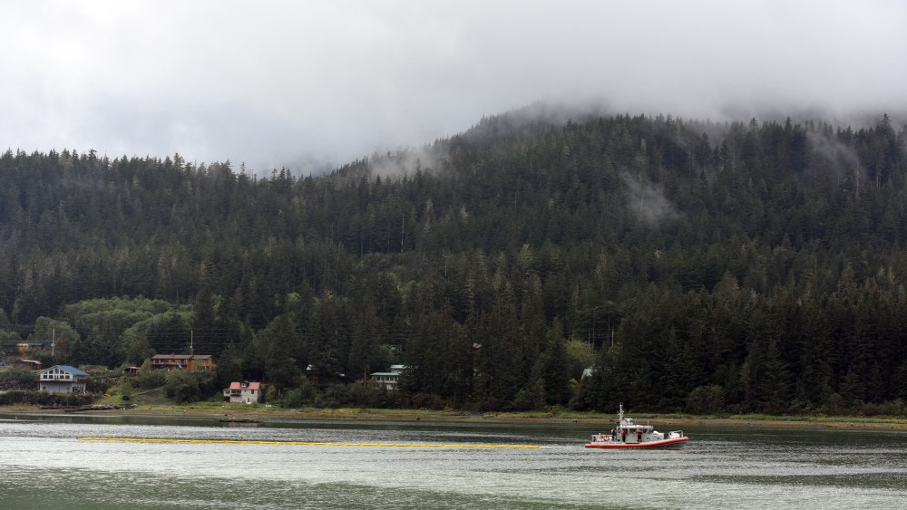 A Coast Guard Station Juneau boat tows a section of containment boom on Sept. 13, 2015, in Juneau, Alaska. (Photo by Grand DeVuyst/U.S. Coast Guard/AP)