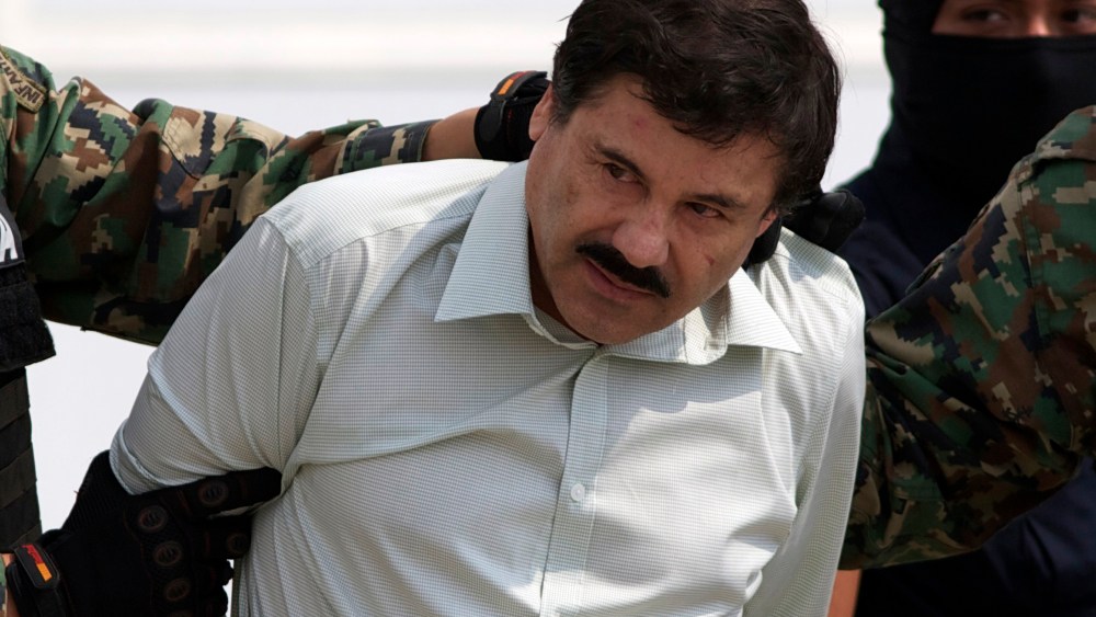 Joaquin "El Chapo" Guzman is escorted to a helicopter in handcuffs by Mexican navy marines at a navy hanger in Mexico City, Feb. 22, 2014. (Photo by Eduardo Verdugo/AP)