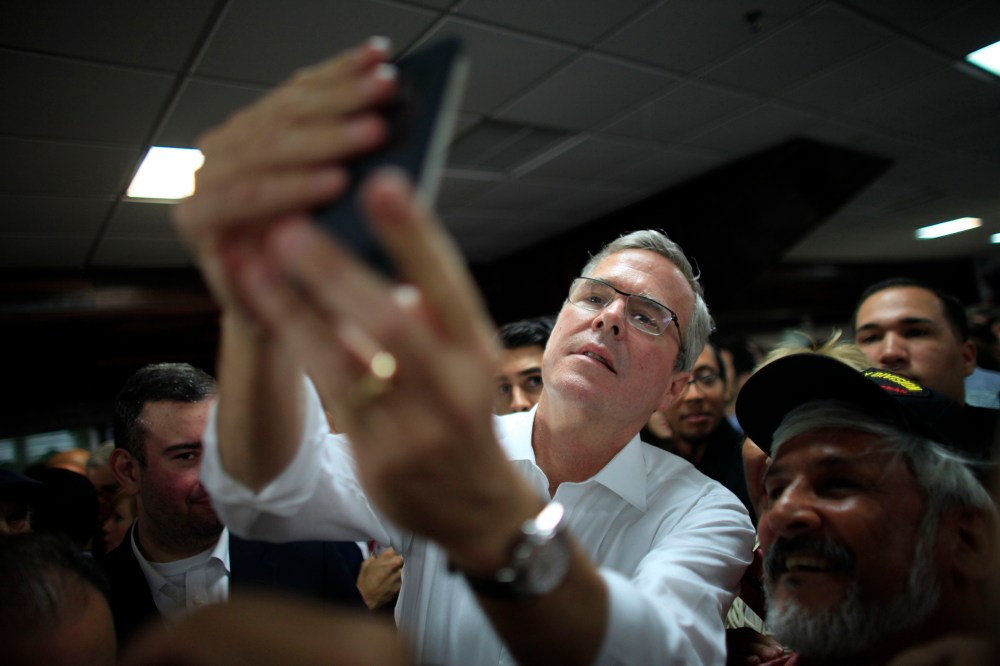 Former Florida Gov. Jeb Bush takes a selfie with a supporter's phone in Bayamon, Puerto Rico, Tuesday, April 28, 2015. (Photo by Ricardo Arduengo/AP)