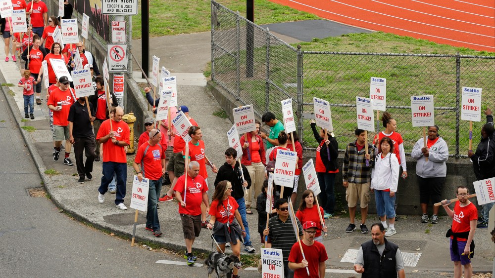Striking Seattle School District teachers and other educators walk a picket line, Thursday, Sept. 10, 2015, near Franklin High School in Seattle. (Photo by Ted S. Warren/AP)