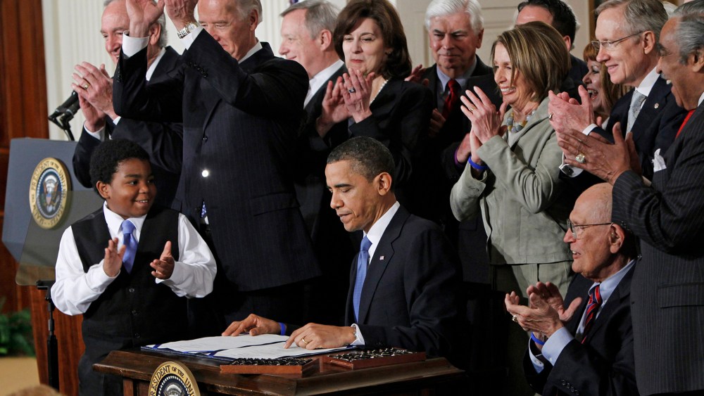 In this March 23, 2010, file photo, President Barack Obama is applauded after signing the Affordable Care Act into law in the East Room of the White House in Washington. (Photo by Charles Dharapak/AP)